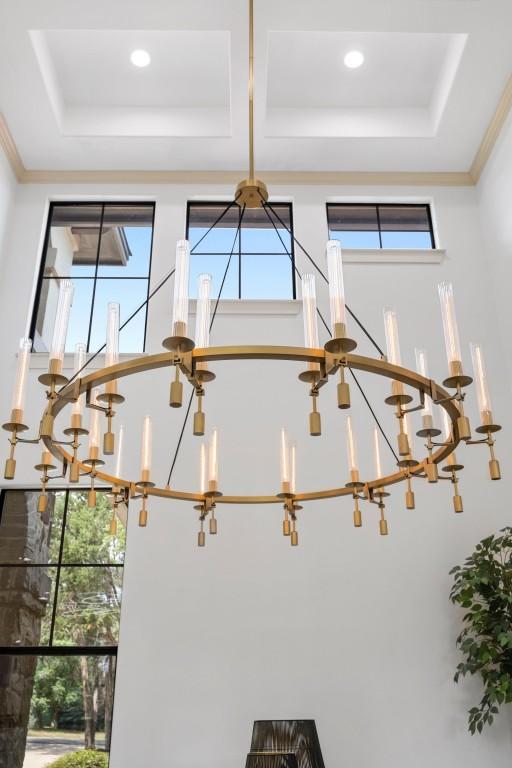 detailed view of a raised ceiling and a chandelier