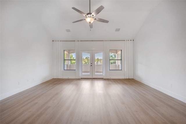 unfurnished room with vaulted ceiling, ceiling fan, french doors, baseboards, and light wood-style floors