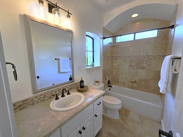 bathroom with toilet, vanity, and  shower combination