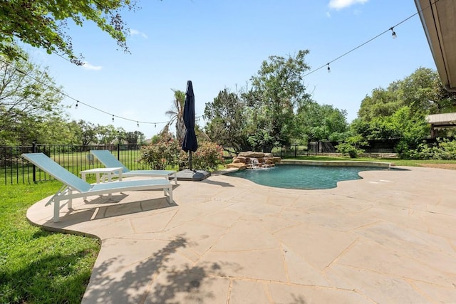 view of swimming pool with fence and a patio