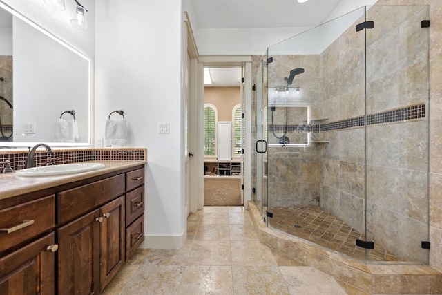 206 Lido St, Austin, TX 78734 - bathroom with a stall shower, vanity, decorative backsplash, and baseboards