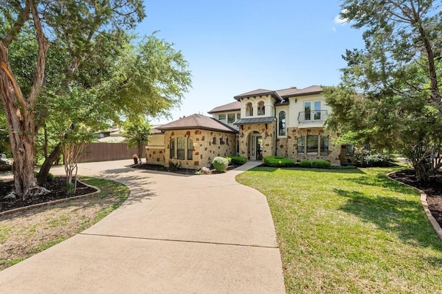 206 Lido St, Austin, TX 78734 - mediterranean / spanish-style home with a balcony, stone siding, and stucco siding