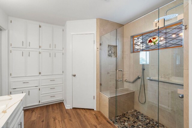 507 Canyon Wren Dr, Buda, TX 78610 - bathroom featuring wood finished floors, a shower stall, and vanity