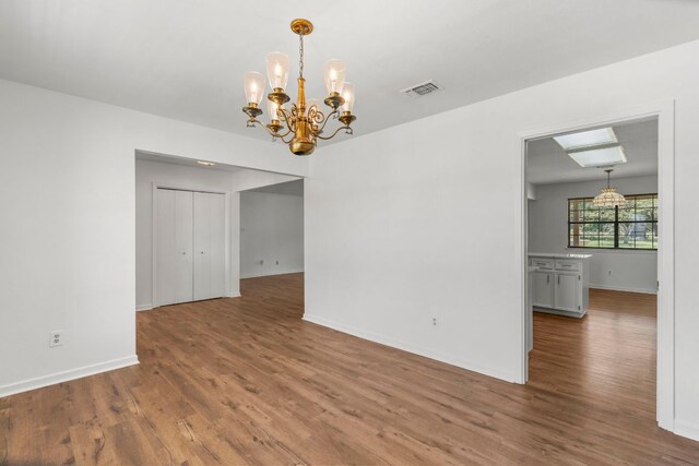 507 Canyon Wren Dr, Buda, TX 78610 - empty room with a chandelier, wood finished floors, and baseboards