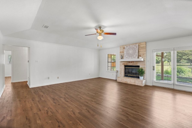 507 Canyon Wren Dr, Buda, TX 78610 - unfurnished living room featuring ceiling fan, dark wood-style flooring, a stone fireplace, vaulted ceiling, and baseboards