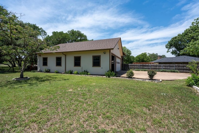 507 Canyon Wren Dr, Buda, TX 78610 - rear view of property featuring a garage, concrete driveway, and stucco siding