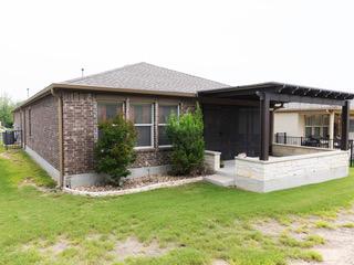 834 Salado Creek Ln, Georgetown, TX 78633 - rear view of property featuring a yard and brick siding
