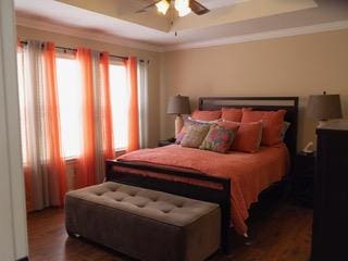834 Salado Creek Ln, Georgetown, TX 78633 - bedroom with a tray ceiling, wood finished floors, and a ceiling fan