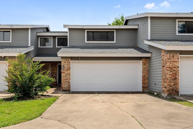 1605 Coronado Hills Dr Unit B, Austin, TX 78752 - multi unit property with an attached garage, brick siding, driveway, and a shingled roof