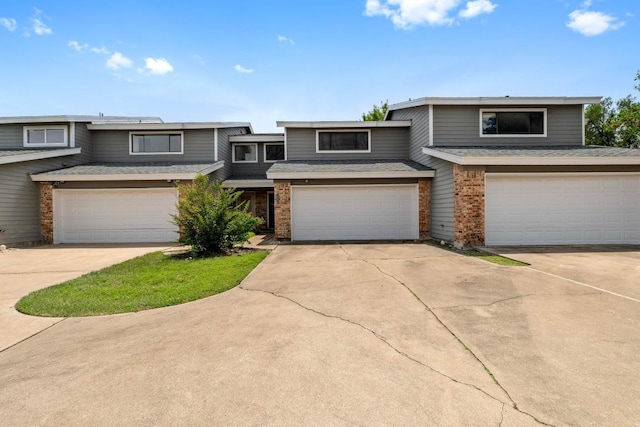1605 Coronado Hills Dr Unit B, Austin, TX 78752 - view of front of home with brick siding, an attached garage, and concrete driveway