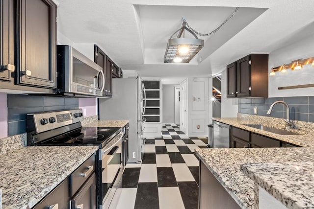 1605 Coronado Hills Dr Unit B, Austin, TX 78752 - kitchen with stainless steel appliances, dark floors, backsplash, and light stone countertops