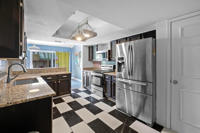 1605 Coronado Hills Dr Unit B, Austin, TX 78752 - kitchen with stainless steel appliances, a sink, a raised ceiling, light flooring, and tasteful backsplash