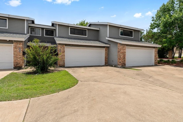 1605 Coronado Hills Dr Unit B, Austin, TX 78752 - view of front of property featuring brick siding, an attached garage, driveway, and a shingled roof
