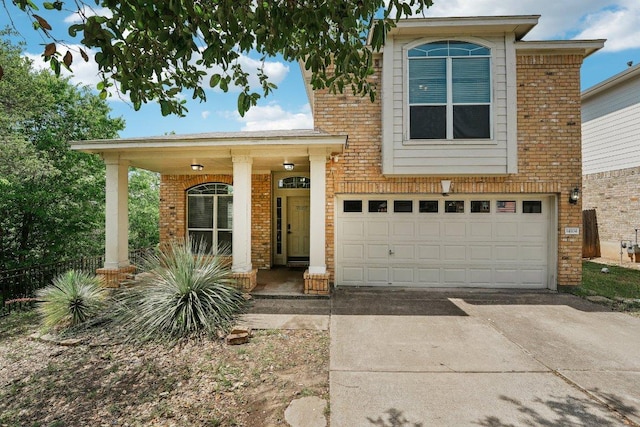 14104 Ballycastle Trl, Austin, TX 78717 - view of front facade featuring brick siding, a porch, concrete driveway, and an attached garage