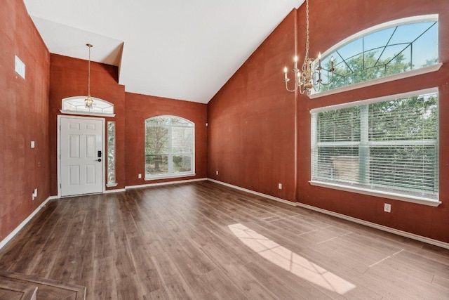 14104 Ballycastle Trl, Austin, TX 78717 - entrance foyer featuring high vaulted ceiling, a chandelier, and wood finished floors