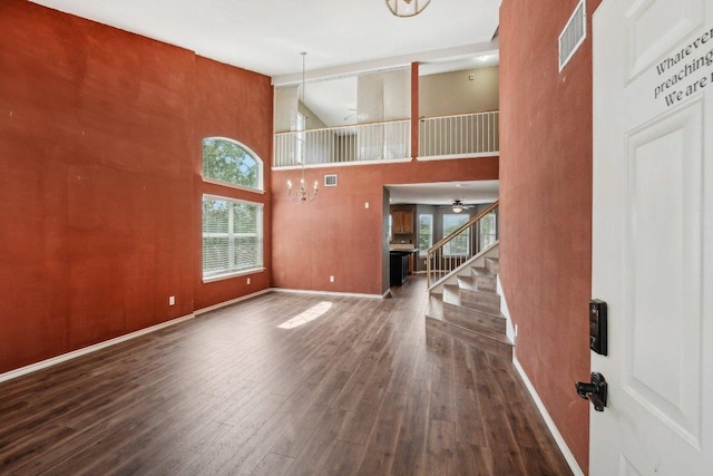 14104 Ballycastle Trl, Austin, TX 78717 - unfurnished living room featuring wood-type flooring, a high ceiling, stairway, and ceiling fan