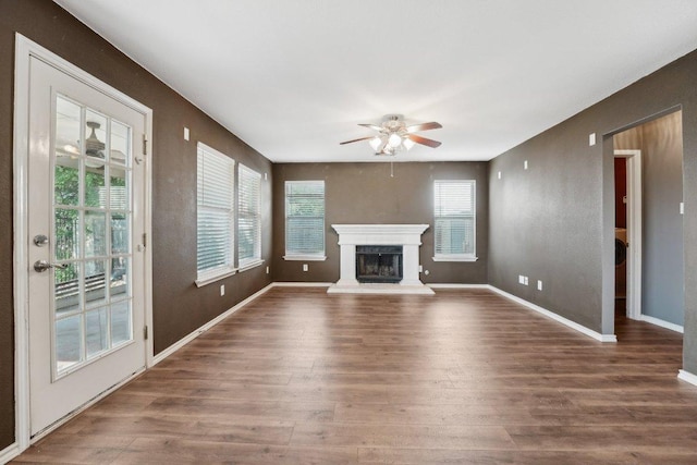 14104 Ballycastle Trl, Austin, TX 78717 - unfurnished living room featuring ceiling fan, wood finished floors, and a fireplace with raised hearth