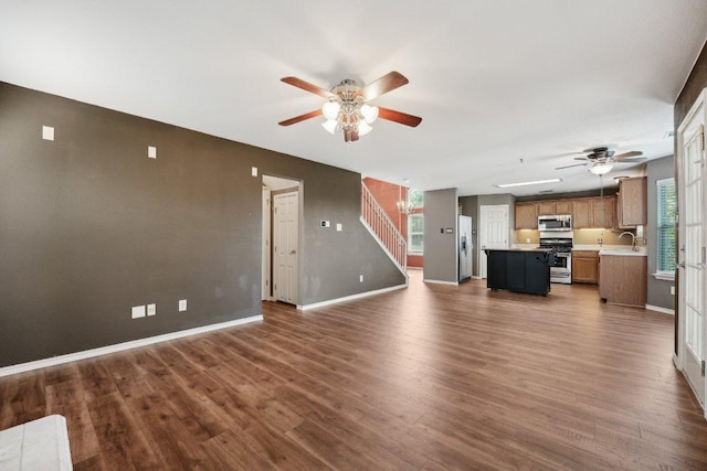 14104 Ballycastle Trl, Austin, TX 78717 - unfurnished living room with a ceiling fan, dark wood-type flooring, and stairs