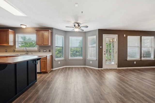 14104 Ballycastle Trl, Austin, TX 78717 - kitchen with ceiling fan, wood finished floors, brown cabinetry, open floor plan, and wooden counters