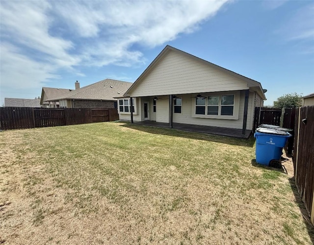 back of property featuring ceiling fan and a patio area