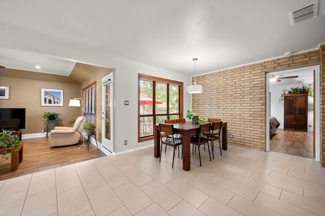 7303 Carlwood Dr, Austin, TX 78759 - dining room with brick wall, baseboards, and light wood-type flooring
