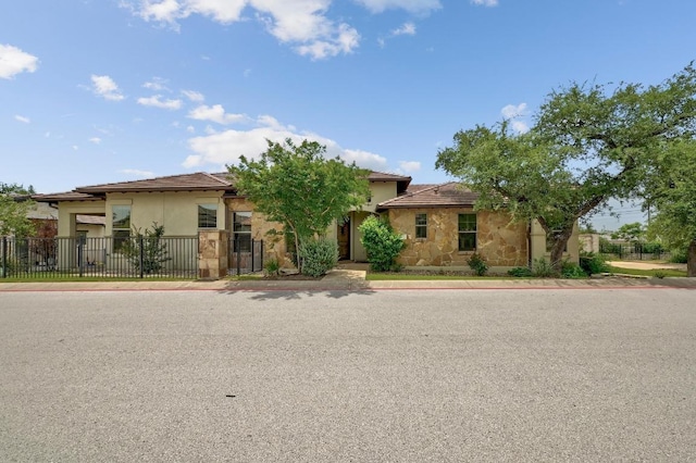 view of front of property with stucco siding and a tile roof