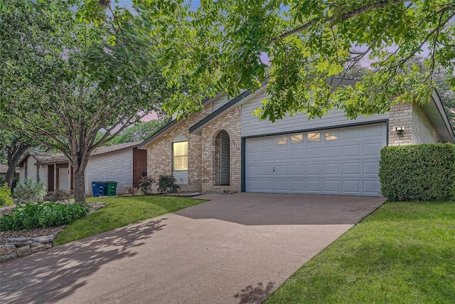 7815 Croftwood Dr, Austin, TX 78749 - view of front of house with brick siding, a garage, concrete driveway, and a front lawn