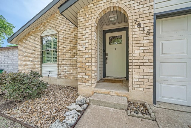 property entrance with brick siding