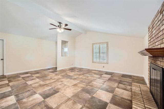 unfurnished living room featuring ceiling fan, a brick fireplace, baseboards, and stone finish flooring