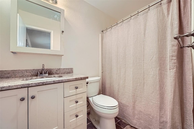 bathroom featuring toilet and vanity