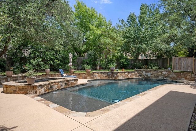 view of swimming pool featuring a fenced backyard, a patio area, and a pool with connected hot tub