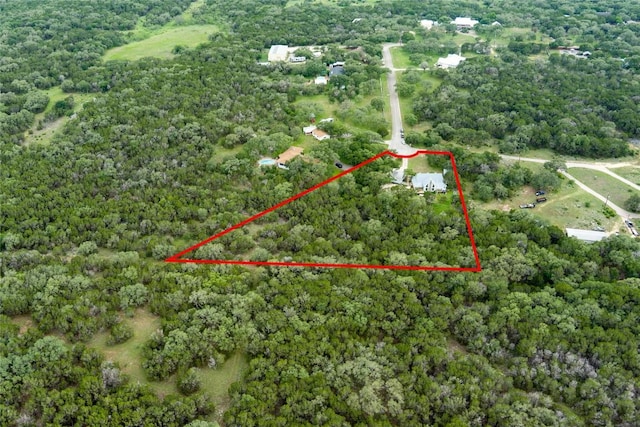 28920 Country Dr, New Braunfels, TX 78132 - aerial view of property and surrounding area featuring property parcel outlined and a heavily wooded area