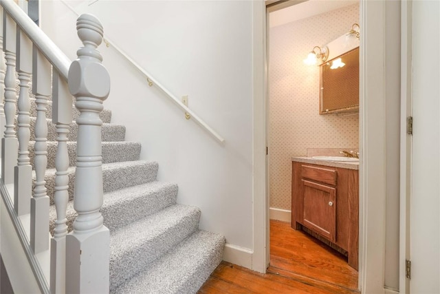28920 Country Dr, New Braunfels, TX 78132 - stairs featuring wood finished floors, baseboards, and wallpapered walls