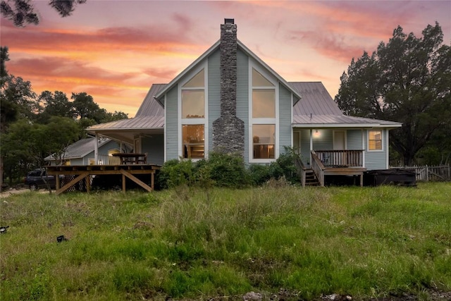 28920 Country Dr, New Braunfels, TX 78132 - rear view of house featuring covered porch, a chimney, and metal roof