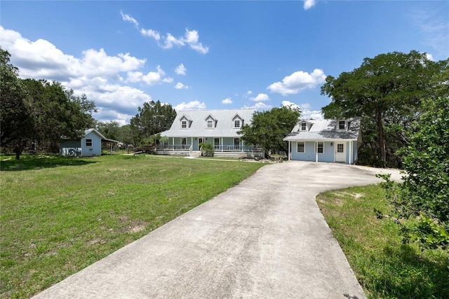 28920 Country Dr, New Braunfels, TX 78132 - cape cod home with a porch, driveway, and a front lawn