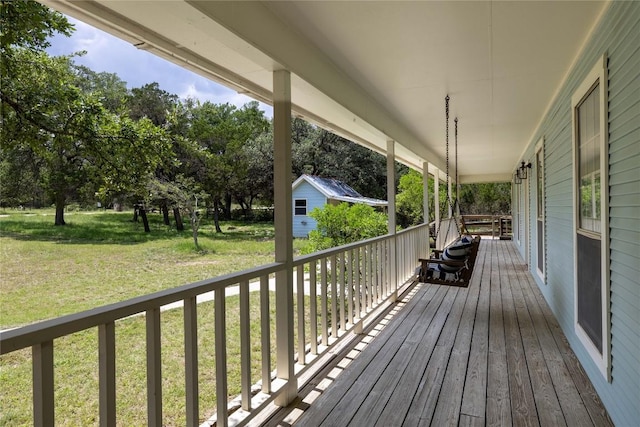 28920 Country Dr, New Braunfels, TX 78132 - wooden terrace featuring covered porch, a yard, and an outbuilding