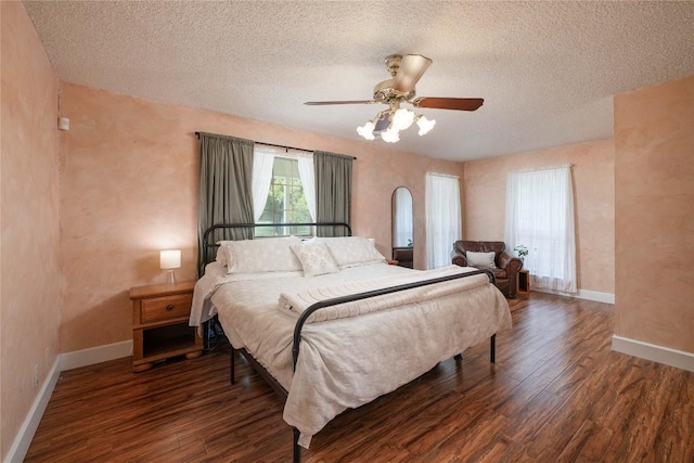 28920 Country Dr, New Braunfels, TX 78132 - bedroom featuring wood finished floors, a textured ceiling, baseboards, and a ceiling fan