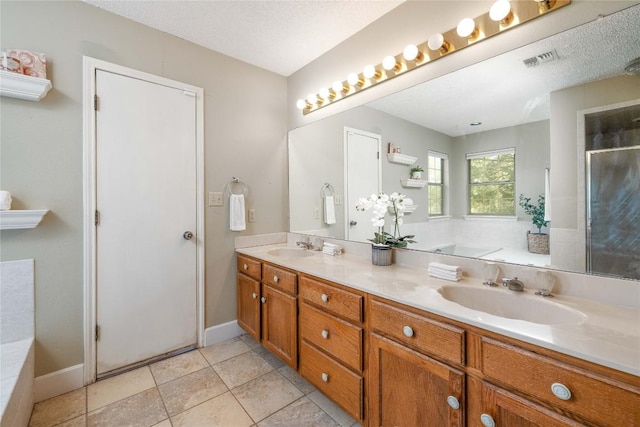 28920 Country Dr, New Braunfels, TX 78132 - full bathroom with double vanity, a bath, an enclosed shower, tile patterned floors, and baseboards