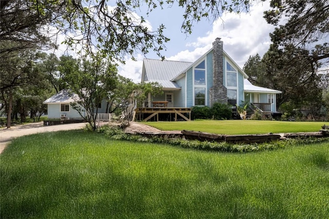 28920 Country Dr, New Braunfels, TX 78132 - rear view of property with a chimney, metal roof, a yard, and a wooden deck