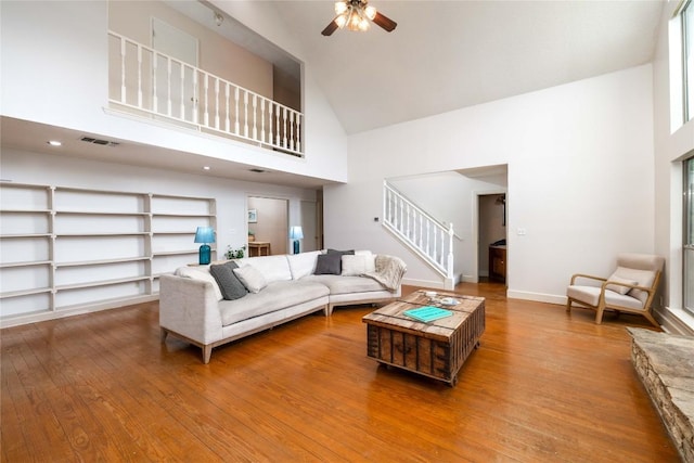 28920 Country Dr, New Braunfels, TX 78132 - living room with high vaulted ceiling, stairway, a ceiling fan, wood finished floors, and baseboards