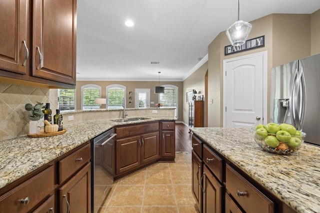 313 Monahans Dr, Georgetown, TX 78628 - kitchen featuring appliances with stainless steel finishes, a peninsula, decorative backsplash, light stone counters, and crown molding
