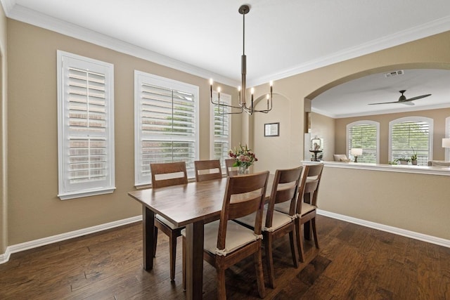 313 Monahans Dr, Georgetown, TX 78628 - dining room featuring dark wood-style floors, a ceiling fan, arched walkways, crown molding, and a chandelier