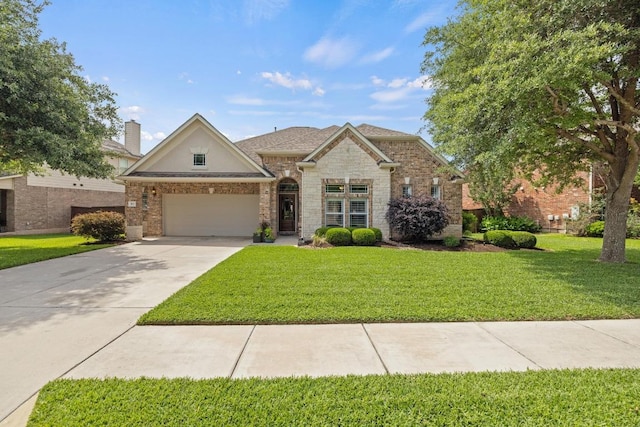 313 Monahans Dr, Georgetown, TX 78628 - view of front of property featuring concrete driveway, a front yard, a garage, and stone siding