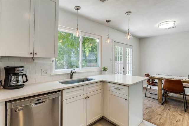 809 Meadowcreek Dr, Round Rock, TX 78664 - kitchen with dishwasher, a sink, backsplash, decorative light fixtures, and white cabinetry