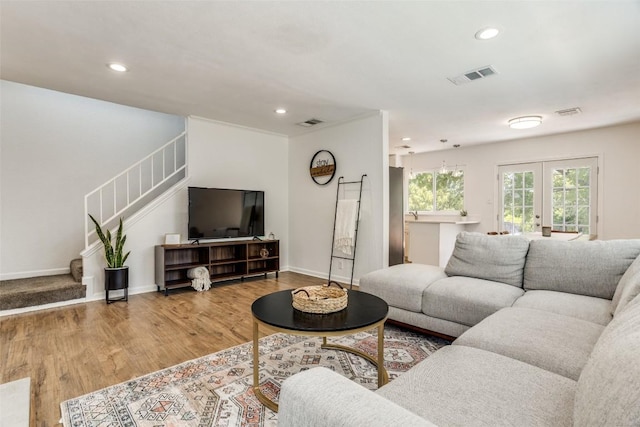 living room with recessed lighting, stairs, wood finished floors, and baseboards
