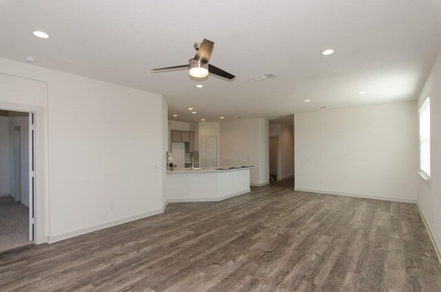 217 Deserti Rd, Leander, TX 78641 - unfurnished living room with dark wood finished floors, a ceiling fan, and recessed lighting