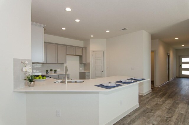 217 Deserti Rd, Leander, TX 78641 - kitchen featuring a sink, gray cabinetry, recessed lighting, tasteful backsplash, and a peninsula