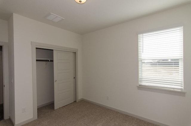 217 Deserti Rd, Leander, TX 78641 - unfurnished bedroom featuring light carpet, multiple windows, a closet, and baseboards