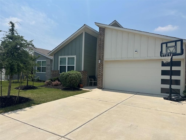 217 Deserti Rd, Leander, TX 78641 - view of front of house with board and batten siding, driveway, an attached garage, a front lawn, and brick siding