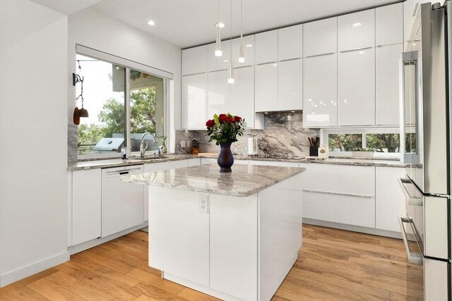 5728 Misty Hill Cv, Austin, TX 78759 - kitchen with high end refrigerator, modern cabinets, white dishwasher, a sink, and recessed lighting